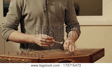 Someone is playing the ethnic musical instrument - santur.