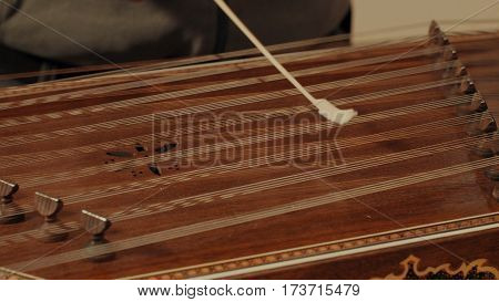 Someone is playing the ethnic musical instrument - santur. Close up