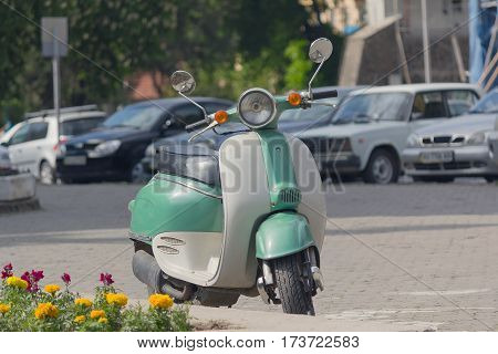 Retro scooter parked on a city street. Transport