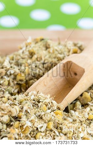 Wooden Measuring Spoon In Dry Chamomile Tea