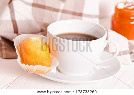 Breakfast with plumcake and orange juice on white dish.