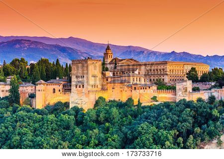 Granada, Spain. Alhambra fortress illuminated at sunset.