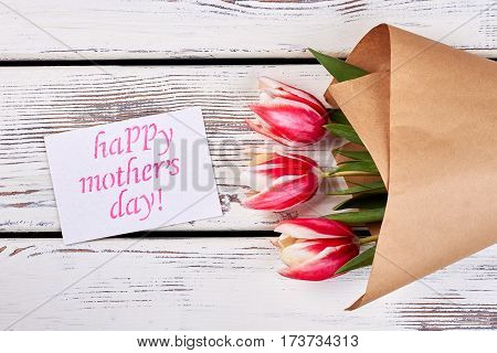 Flowers and card on wood. Surprise for dearest person.
