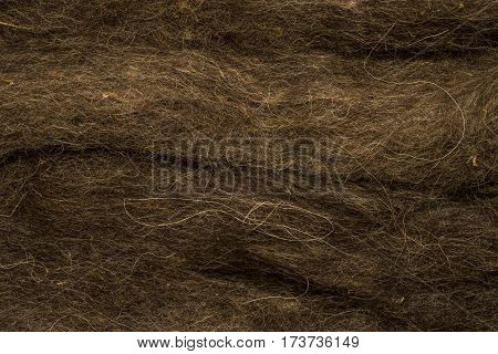 Brown sheep's wool for felting texture. Natural abstract background