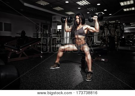 Sexy Fitness Woman In Sport Wear With Perfect Fitness Body In Gym Performing Shoulder Exercises With