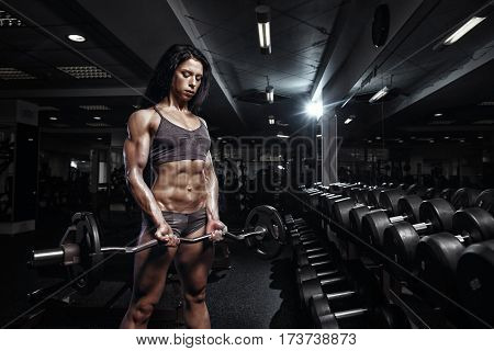 Sexy Fitness Woman In Sport Wear With Perfect Fitness Body In Gym Performing Biceps Exercises With E