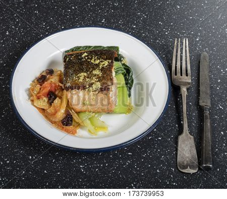 grilled fresh samon fillet with vegetables on black