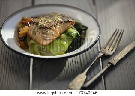 grilled fresh samon fillet with vegetables on wooden background