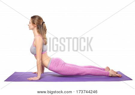 Attractive young sporty girl practicing yoga postures. White background.