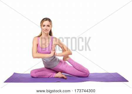 Attractive young sporty girl practicing yoga postures. White background.