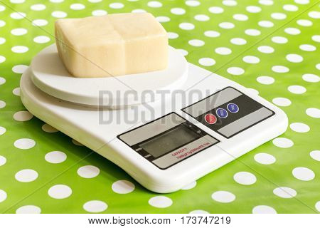 Yellow Cheese On The Kitchen Digital Scale