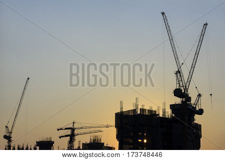 The under construction building and the crane with the silhouette scene