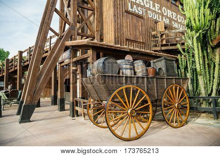 PORT AVENTURA/ SPAIN - MAY 11, 2015. Old wooden wagon near the attraction Wild Buffalos in the Far West area of theme park Port Aventura in city Salou, Spain.