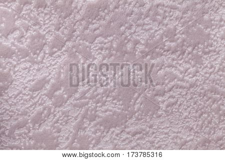 Pearl lilac background from a soft upholstery textile material closeup. Fabric with natural texture. Cloth backdrop.