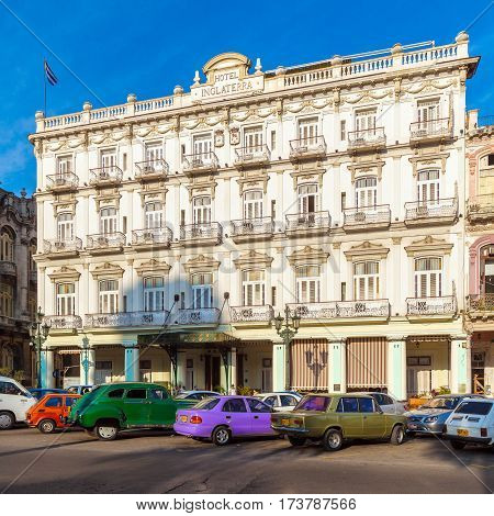 Havana, Cuba - April 2, 2012: Cubans Walk The Streets Of The Town Near Hotel Inglaterra