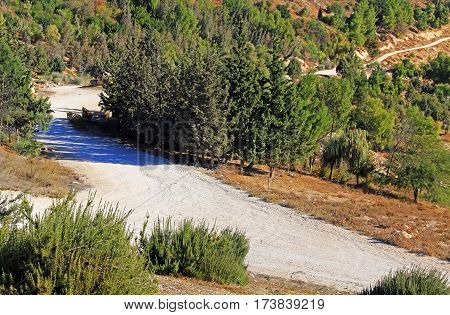 Rocky dirt road winding beside the Judean desert wilderness as seen from Mt. Scopus in Jerusalem, Israel.