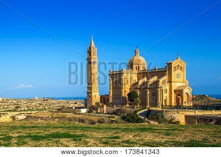 Gozo Malta - The Basilica of the National Shrine of the Blessed Ta' Pinu early at the morning with clear blue sky on a summer day