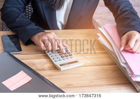 Finger accountant pressing on calculator in office