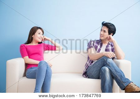 young couple look somewhere with blue background