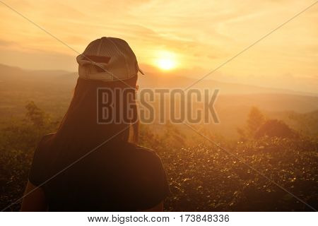 Tourists watching sunsets behind the mountainsSilhouette Concept