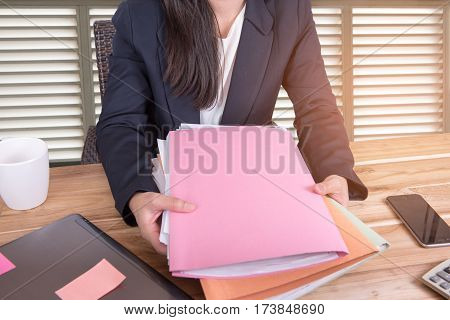 Women hold the folder on the desk in office