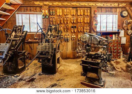 ZAANSE SCHANS, NETHERLANDS - JULY 08, 2015: Vintage machine tools in small workshop in Zaanse Schans producing klompen (clogs) - famous traditional dutch footwear made completely from wood.