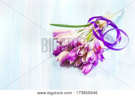 Bouquet of crocuses on a wooden table