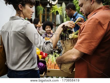 People Buying Vegetable From Shop at Market