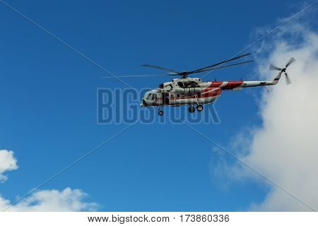 Kamchatka Peninsula, Russia - August 20, 2016: Sightseeing helicopter MI-8 for tourists in the cloudy sky