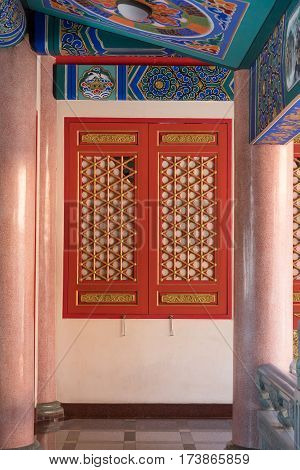 Traditional and architecture red window chinese style temple at Wat Mangkon Kamalawat or Wat Leng Noei Yi in NonthaburiThailand.