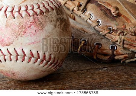 A close up image of old and dirty baseball equipment.