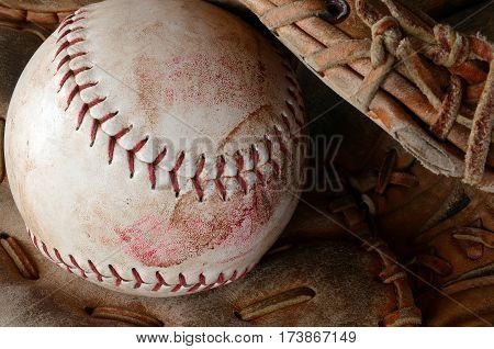 A close up image of old and dirty baseball equipment.