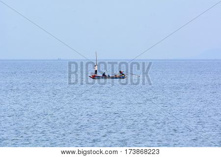 Small fishing boats in the sea on the day of sea peacetime.