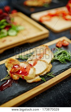 Tasty chicken steak with tomato sauce and aromatic herbs