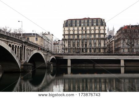 Lyon, France - December 20, 2016: Quay of the river Rhone and Wilson Bridge. On the background Basilica of Notre-Dame de Fourviere in December 20 in Lyon, France