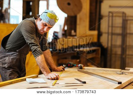 Repairman or cabinetmaker looking at sketch of new detail