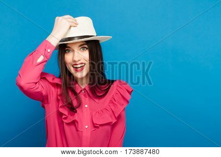 Beautiful Woman In Hat. Retro Fashion. Blue Background.