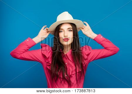 Beautiful Woman In Hat. Retro Fashion. Blue Background.