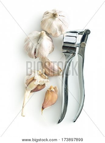 Garlic and garlic press isolated on white background.