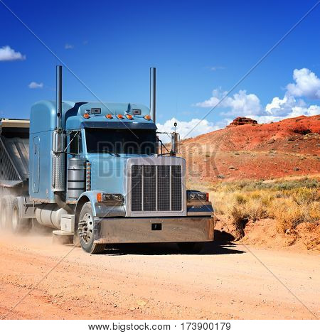 Semi-truck driving across the desert west of USA