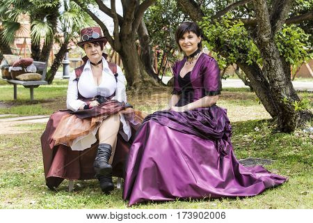 CAGLIARI, ITALY - June 1, 2014: Sunday at La Grande Jatte public gardens - portrait of beautiful women in Victorian costumes - Sardinia