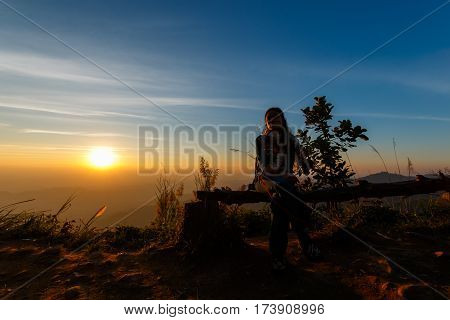 Beauty asian woman in green sweater and scarf on beautiful sunset background