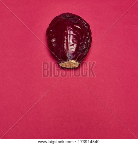 The fresh red cabbage on a red background