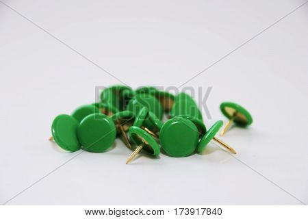 bunch of round green push pins on a white background