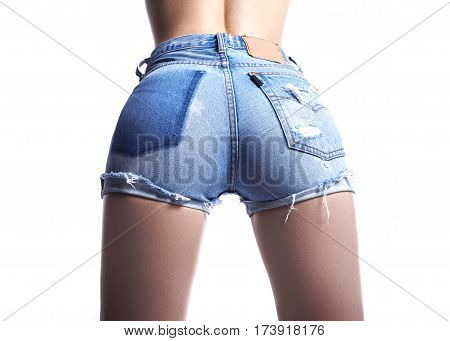 Sexy woman in fashion blue jeans shorts. Perfect hot booty and erotic curves hips. Good body shapes whithout cellulite. Sport and diet.