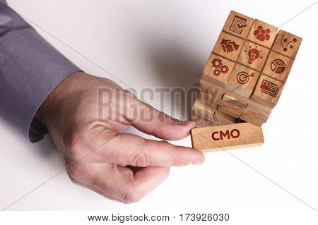 Business, Technology, Internet And Network Concept. Young Businessman Shows The Word: Cmo