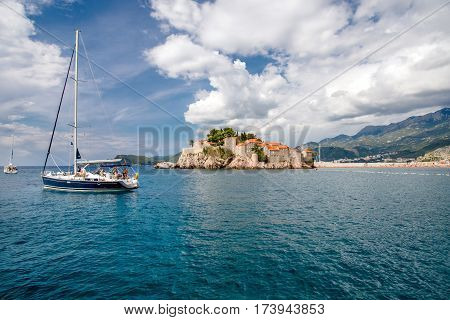 Sveti Stefan, MONTENEGRO - SEPTEMBER 22, 2016:Tourists sailing on a yacht near the island of Sveti Stefan, Montenegro.
