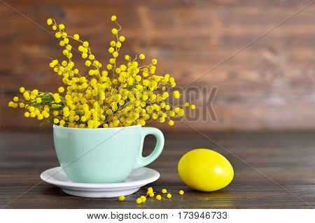 Easter card: Mimosa in the cup and Easter egg