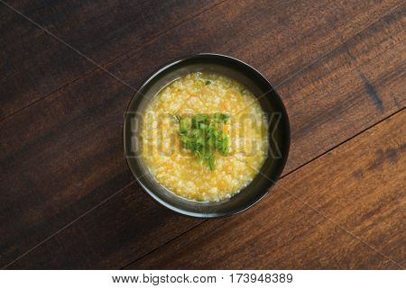 Top view porridge bowl on wooden table background.