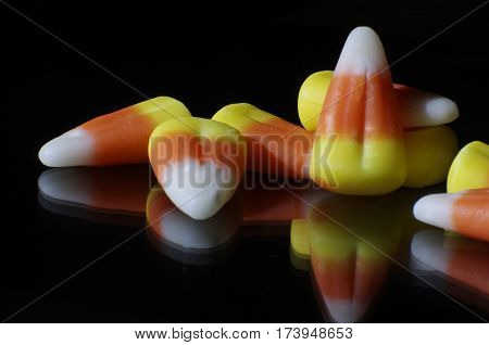 close up of Halloween candy corn on black